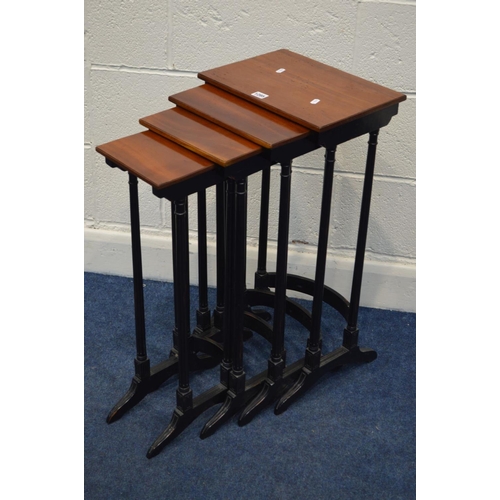 1285 - A REPRODUCTION MAHOGANY TOPPED QUARTETTO NEST OF FOUR TABLES, in an Edwardian style, on an ebonised ... 