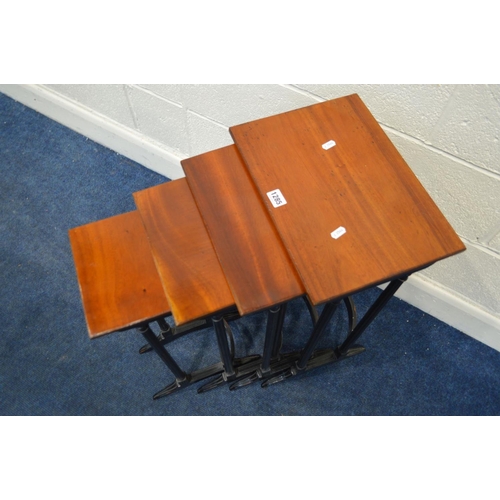 1285 - A REPRODUCTION MAHOGANY TOPPED QUARTETTO NEST OF FOUR TABLES, in an Edwardian style, on an ebonised ... 