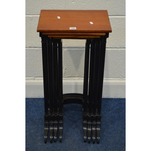 1285 - A REPRODUCTION MAHOGANY TOPPED QUARTETTO NEST OF FOUR TABLES, in an Edwardian style, on an ebonised ... 