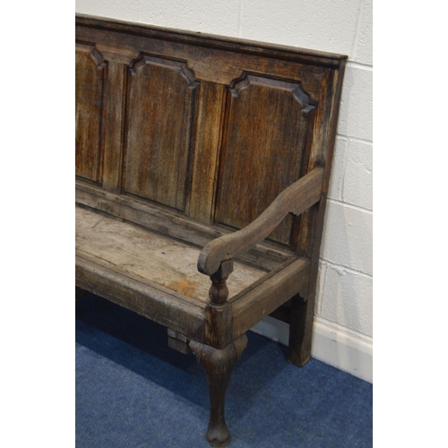 1290 - A DISTRESSED GEORGIAN OAK HALL SETTLE, having four fielded panels, swept armrests, on triple cabriol... 