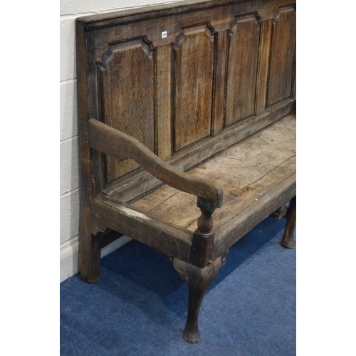 1290 - A DISTRESSED GEORGIAN OAK HALL SETTLE, having four fielded panels, swept armrests, on triple cabriol... 