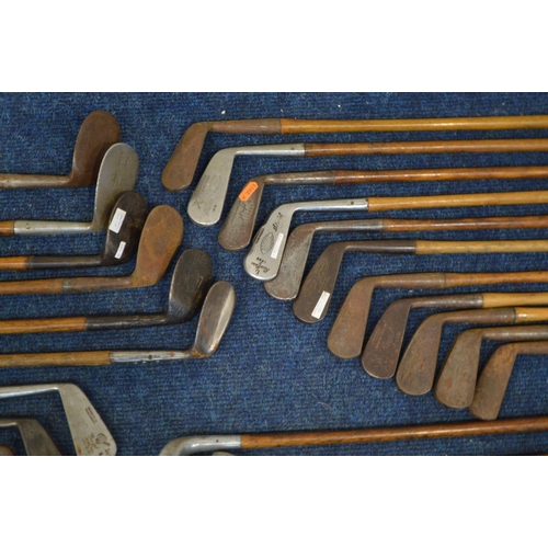 1292 - A LARGE COLLECTION OF VINTAGE HICKORY SHAFTED GOLF CLUBS, to include mainly irons, putters, woods, t... 