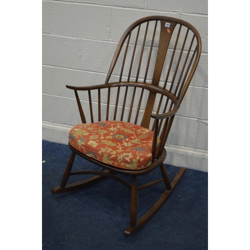 1303 - AN ERCOL GOLDEN DAWN ASH CHAIRMAKERS WINDSOR ROCKING CHAIR, on a crinoline stretcher, with a removab... 