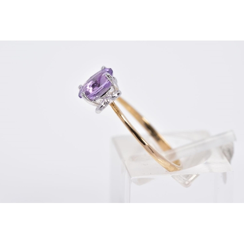 38 - A 9CT GOLD AMETHYST AND DIAMOND RING, designed with a claw set, oval cut amethyst, with heart shaped... 