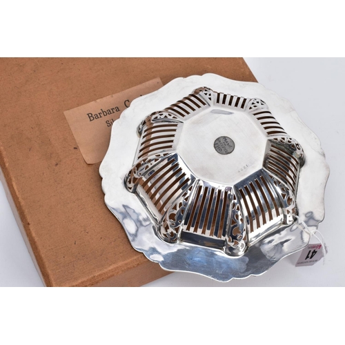 41 - A BARBARA CATTLE SILVER DISH, the bowl of openwork panels and scroll design, with a wavey detailed t... 