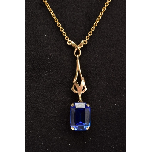 51 - A YELLOW METAL SAPPHIRE PENDANT NECKLACE, designed with an openwork drop detailed pendant with a cla... 