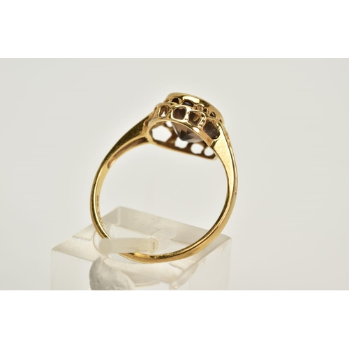 52 - A 9CT GOLD SMOKEY QUARTZ RING, designed with an oval cut smokey quartz within a collet mount, openwo... 