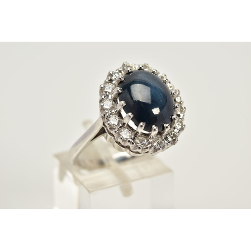 55 - A MODERN 18CT WHITE GOLD LARGE STAR SAPPHIRE AND DIAMOND OVAL CLUSTER RING, star sapphire measuring ... 