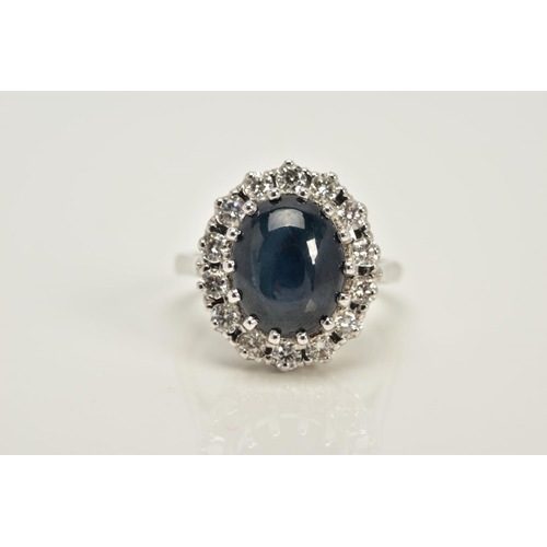 55 - A MODERN 18CT WHITE GOLD LARGE STAR SAPPHIRE AND DIAMOND OVAL CLUSTER RING, star sapphire measuring ... 