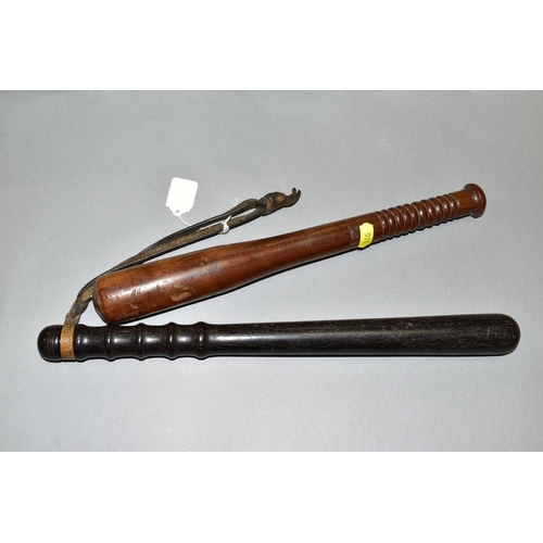 571 - TWO WOODEN TRUNCHEONS, one stamped BPB146, length approximately 39cm, leather wrist strap to handle,... 