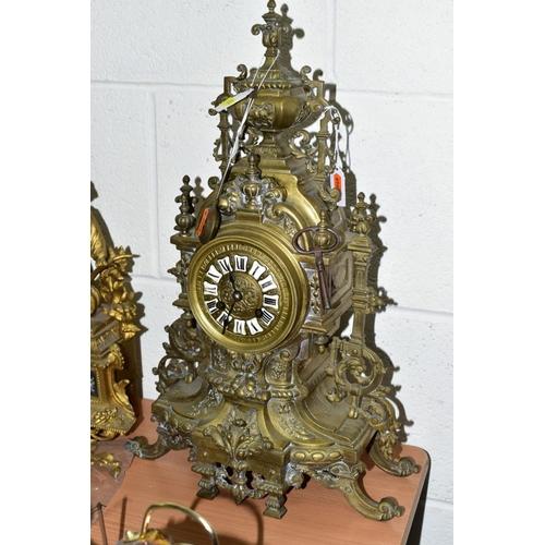 612 - A LATE 19TH CENTURY BRASS MANTEL CLOCK OF ORNATE DESIGN, enamelled Roman numerals, eight day movemen... 