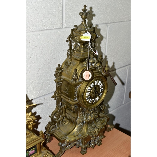 612 - A LATE 19TH CENTURY BRASS MANTEL CLOCK OF ORNATE DESIGN, enamelled Roman numerals, eight day movemen... 