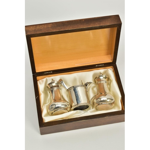 91 - A CASED THREE PIECE SET OF SILVER, to include a plain polished designed salt and pepper pot together... 