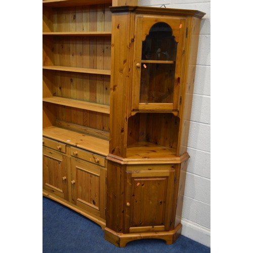 1332 - A TALL PINE OPEN BOOKCASE, with four fixed shelves, above two drawers and double cupboard doors, wid... 