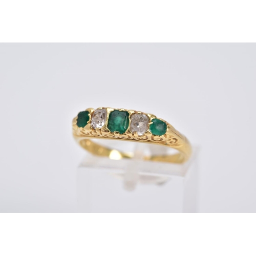 20 - AN EARLY 20TH CENTURY EMERALD AND DIAMOND RING, designed with a central emerald cut emerald interspa... 