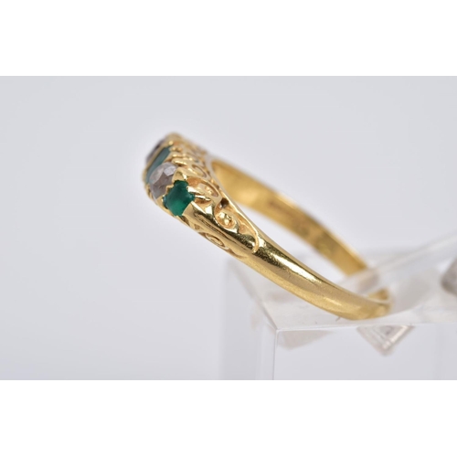 20 - AN EARLY 20TH CENTURY EMERALD AND DIAMOND RING, designed with a central emerald cut emerald interspa... 