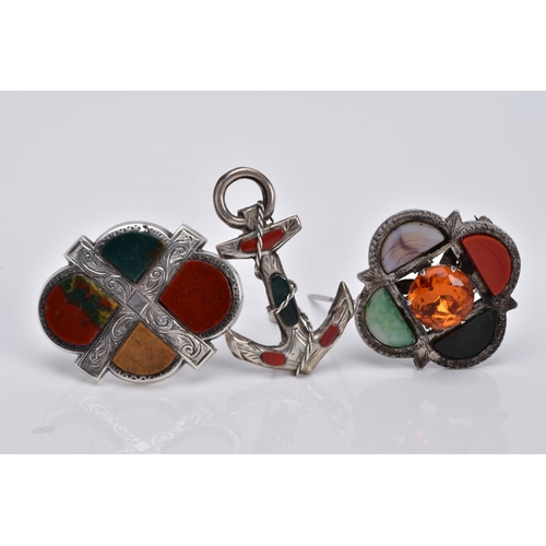 23 - THREE SCOTTISH HARDSTONE BROOCHES, the first designed with a central circular cut orange stone asses... 