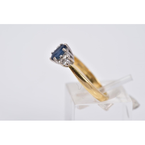 24 - AN 18CT GOLD SAPPHIRE AND DIAMOND RING, designed with a central oval cut sapphire flanked by three r... 