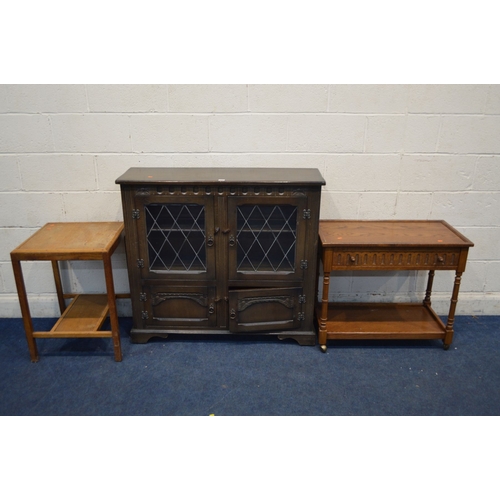 1342 - AN OAK LEAD GLAZED TWO DOOR BOOKCASE, together with an oak tea trolley with a single drawer and oak ... 