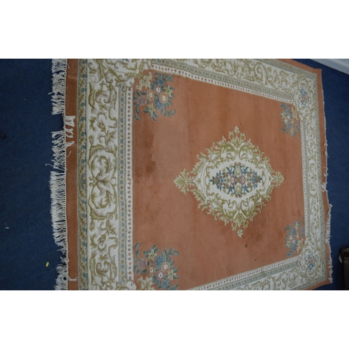 1349 - A CHINESE WOOLEN GROUND RUG, orange field with a central medallion, 323cm x 278cm