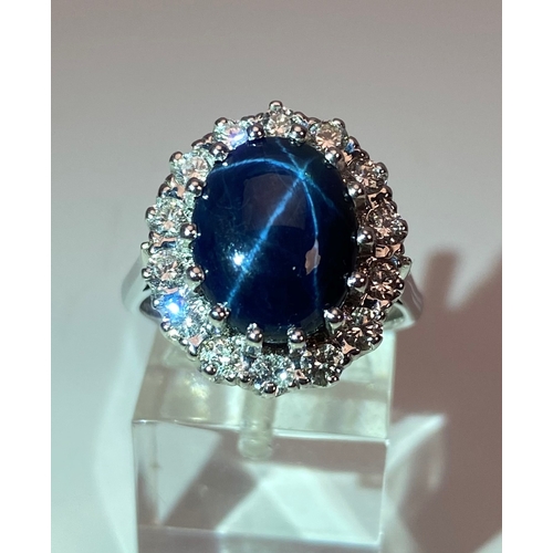 55 - A MODERN 18CT WHITE GOLD LARGE STAR SAPPHIRE AND DIAMOND OVAL CLUSTER RING, star sapphire measuring ... 