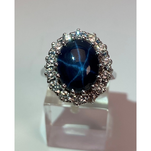 55 - A MODERN 18CT WHITE GOLD LARGE STAR SAPPHIRE AND DIAMOND OVAL CLUSTER RING, star sapphire measuring ... 