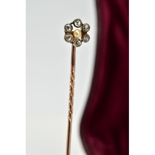 10 - A DIAMOND AND SEED PEARL STICK PIN, the rose coloured metal of flower design set with a central seed... 