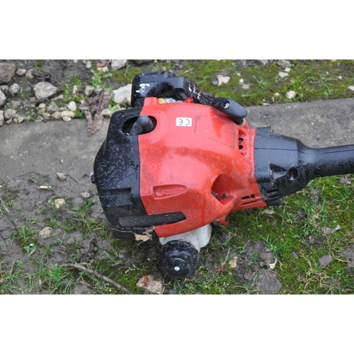 1003 - AN UNBRANDED PETROL STRIMMER (engine pulls freely but hasn't been started)