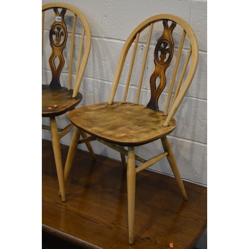 1208 - A PAIR OF ERCOL PRINCE OF WALES CHAIRS (partially stripped) together with an oak coffee table, a mod... 