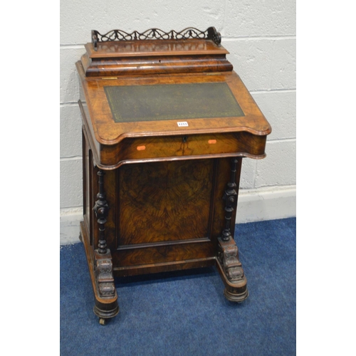 1211 - A LATE VICTORIAN WALNUT DAVENPORT, fretwork gallery on a hinged stationary compartment, a sloping li... 