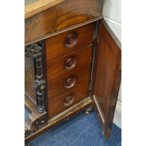 1211 - A LATE VICTORIAN WALNUT DAVENPORT, fretwork gallery on a hinged stationary compartment, a sloping li... 