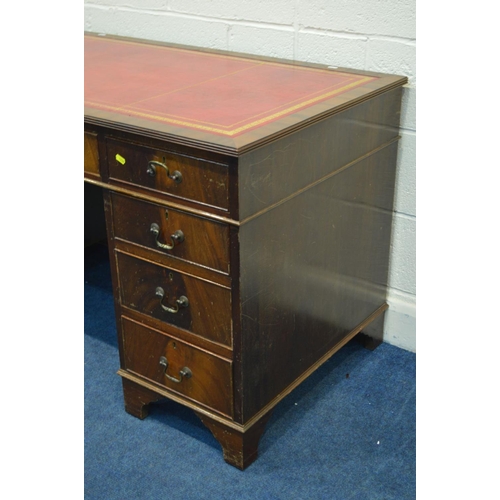 1234 - A MAHOGANY PEDESTAL DESK, with a red and gilt tooled leather inlay top, and nine various drawers, wi... 