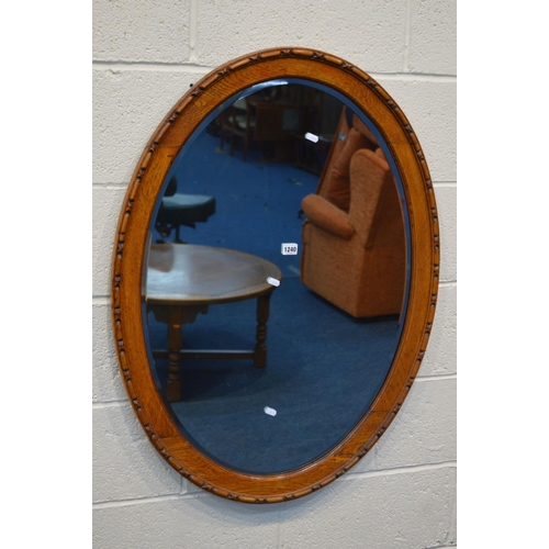 1240 - AN EARLY TO MID 20TH CENTURY OAK OVAL BEVELLED EDGE WALL MIRROR, 97cm x 72cm