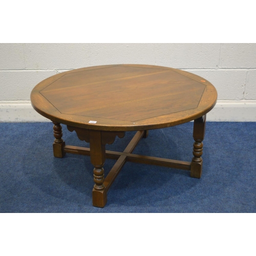 1241 - AN OLD CHARM OAK CIRCULAR COFFEE TABLE, on a cross stretchered base, diameter 99cm x height 48cm (mi... 