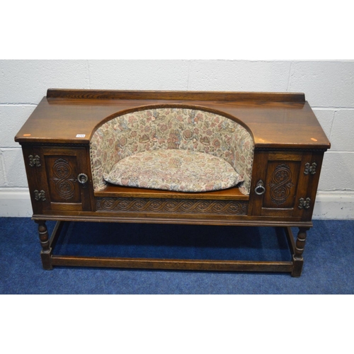 1244 - AN OLD CHARM OAK TELEPHONE TABLE/SEAT, flanked by single cupboard doors, width 118cm x depth 43cm x ... 