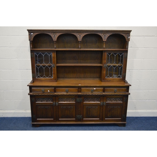 1248 - AN OLD CHARM OAK DRESSER with double lead glazed doors, four frieze drawers over two double cupboard... 