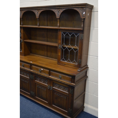 1248 - AN OLD CHARM OAK DRESSER with double lead glazed doors, four frieze drawers over two double cupboard... 