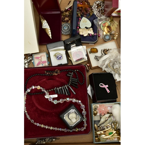 126 - A BOX OF COSTUME JEWELLERY to include various base metal brooches, rings, wristwatches, necklaces, e... 