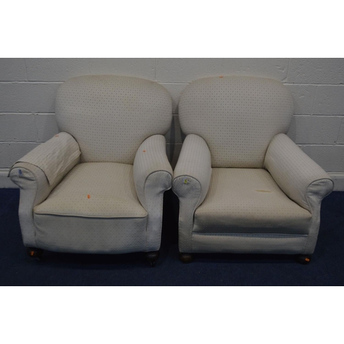 1274 - IN THE MANNER OF HOWARD AND SONS, a pair of early 20th Century cream upholstered armchairs, on bun f... 