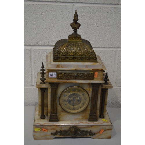 1301 - AN EARLY 20TH CENTURY MARBLE AND BRASS FRENCH MANTEL CLOCK, with a Roman figure finial, the brass di... 