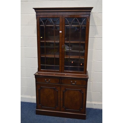 1304 - A MODERN MAHOGANY DOUBLE DOOR BOOKCASE, with two drawers, width 100cm x depth 41cm x height 201cm (t... 