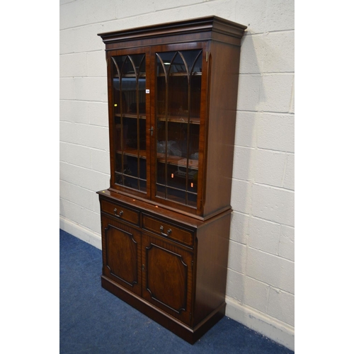 1304 - A MODERN MAHOGANY DOUBLE DOOR BOOKCASE, with two drawers, width 100cm x depth 41cm x height 201cm (t... 