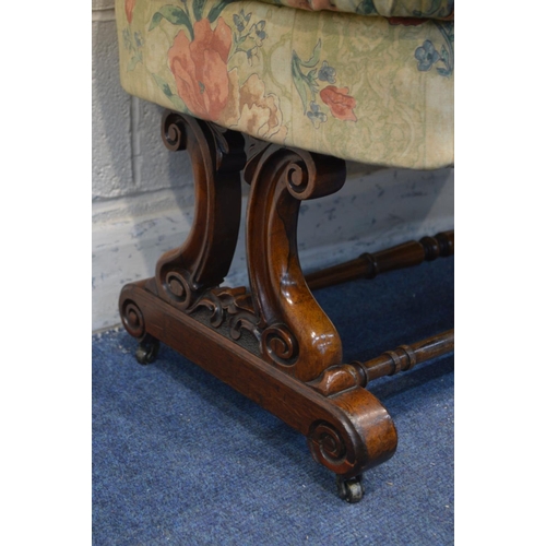 1310 - A VICTORIAN ROSEWOOD SERPENTINE STOOL, later floral buttoned upholstery, on twin foliate and scrolle... 