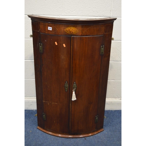 1321 - A GEORGIAN MAHOGANY AND INLAID BOWFRONT DOUBLE DOOR HANGING CORNER CUPBOARD, painted interior above ... 