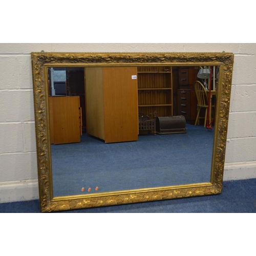 1329 - A LARGE LATE 20TH CENTURY FOLIATE GILT WOOD BEVELLED EDGE WALL MIRROR, 140cm x 110cm