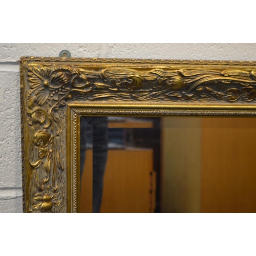 1329 - A LARGE LATE 20TH CENTURY FOLIATE GILT WOOD BEVELLED EDGE WALL MIRROR, 140cm x 110cm