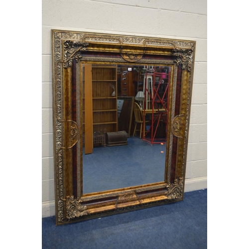 1330 - A LARGE LATE 20TH CENTURY FOLIATE GILT WOOD BEVELLED EDGE WALL MIRROR, 141cm x 173cm x depth 10cm (s... 