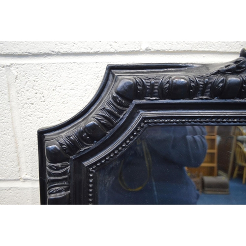 1331 - A LARGE LATE 20TH CENTURY EBONISED WOOD BEVELLED EDGE OVERMANTEL MIRROR, with a foliate and scrolled... 