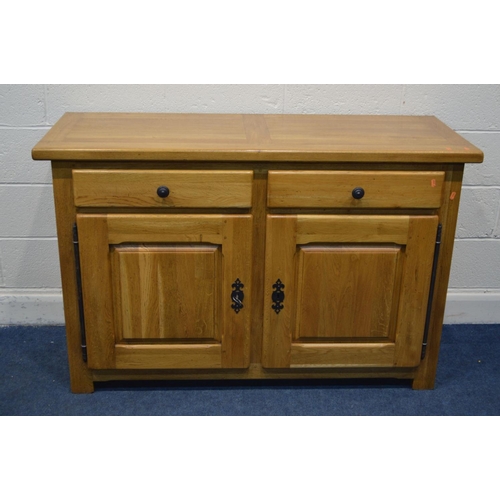 1335 - A SOLID GOLDEN OAK SIDEBOARD, with two drawers above double fielded panel cupboard doors, width 141c... 