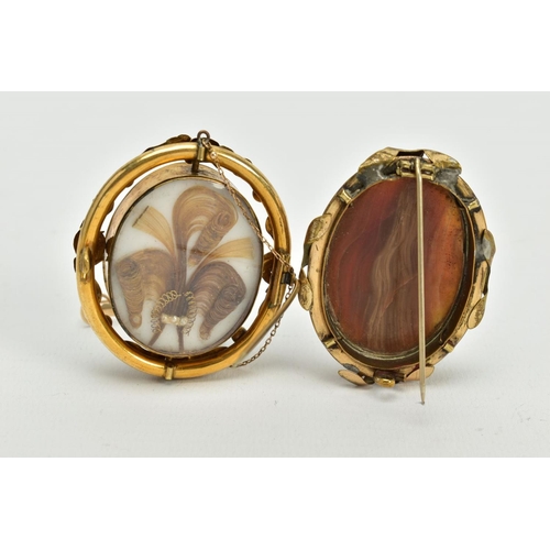 169 - TWO YELLOW METAL BROOCHES, to include a cameo swivel memorial brooch, the cameo depicting the three ... 